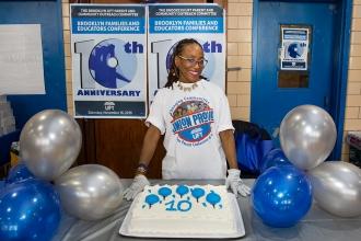 Women with Union Proud t-shirt stand behind a cake that is iced with the number 10