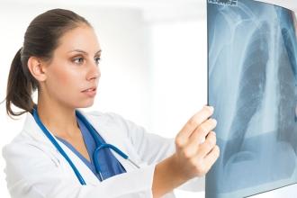 Female medical professional looks at x-rays