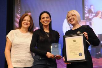 A school social worker accepts an award that is presented to her by UFT Vice President for Special Education MaryJo Ginese (left) and Staten Island paraprofessional borough representative Valeria Morgan-Davis. 
