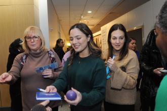 A member picks up UFT items as she enters the 2026 UFT Clinician Appreciation Day.