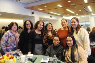 A group of school psychologists and school social take a photo at a table during the 2026 UFT Clinicians Appreciation Day event.