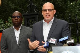 Michael Mulgrew and Leroy Barr in front of press outdoors