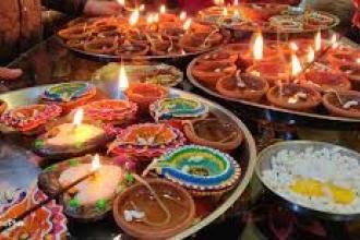 Image of traditional colored snacks and candles for Diwali