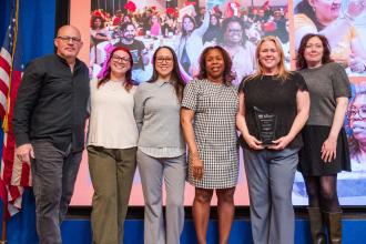 Chapter Leader Amy Craine of the Richmond Pre-K Center on Staten Island (2nd from right) is recognized by UFT Vice President for Elementary Schools Karen Alford (center) and UFT President Michael Mulgrew (left).