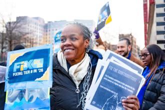 Members of District 7 in the Bronx take to the street and brave the frigid temps on Feb. 6 to hoist signs urging passersby to support fixing Tier 6.