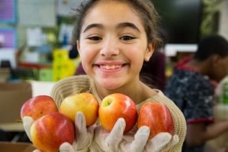 Girl holding apples