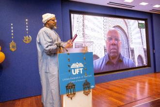 District 9 Representative Aqeel Williams, the UFT liaison to the committee and an event organizer, presents recently retired UFT Secretary LeRoy Barr (on screen) with an award for his leadership and his support of the UFT Muslim Educators Committee during the UFT's annual Iftar celebration on Feb. 12, 2026. 
