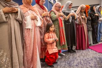A school social worker with her son during prayer at the UFT's annual Iftar celebration on Feb. 27, 2026.