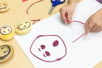 A student wearing a mask participates in art class