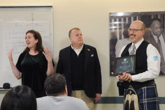 A smiling Niccolich accepts the UFT Irish Heritage Achievement Award from UFT Irish American Heritage Committee Co-Chairs Alice O’Neil and Dennis Gault.