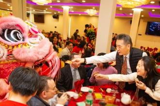 A man puts money into a dancing lion at the UFT Asian Heritage Committee Lunar New Year Banquet on Feb. 28, 2025. 