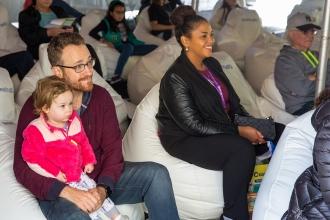Parents and children listen sitting on bean bag chairs