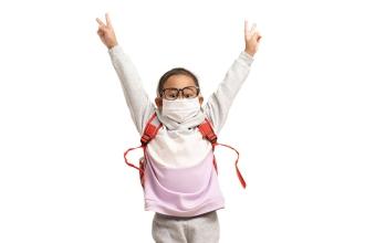 Masked male child with glasses jumping in the air - Generic