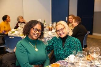 Dolores Mateo (left) and Josefina Baez, who retired in July from PS/IS 201 in Harlem, catch up as they enjoy the luncheon.