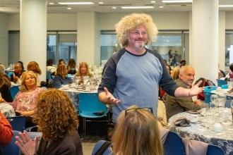 New retiree Adam Cooper, who taught at the Urban Assembly School for Collaborative Healthcare in Brooklyn, reacts to winning an Echo Dot in a raffle during the event.