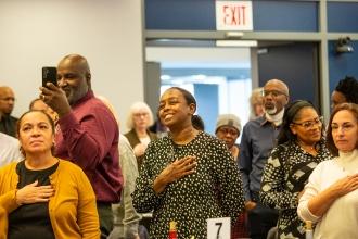 Attendees pay heartfelt attention as the National Anthem is sung.