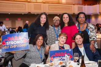 Attendees take a group shot with UFT Paraprofessionals Chapter Chairperson Priscilla Castro at the UFT Paraprofessional Awards Luncheon on March 7, 2026. 