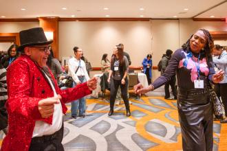 Two colleagues dance together at the UFT Paraprofessional Awards Luncheon on March 7, 2026. 