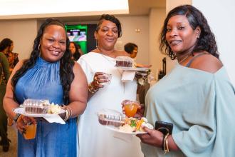 (Left to right) Providers Pensia Sanders, Solange Douglas and Delphina Elcock from Angels of the Sun Daycare celebrate Douglas' Outstanding Professional Services Award.