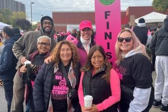 Members from PS 199X take a photo at the finish line of the Making Strides Against Breast Cancer walk in the Bronx on Oct. 26.