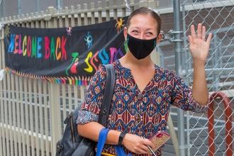 Woman waves at camera
