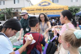 Families pick up school supplies from one of the community partner tables.