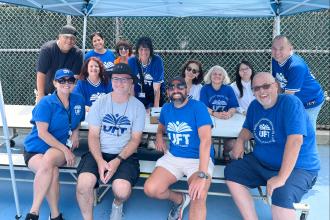 Staten Island Borough Representative Sean Rotkowitz (front, second from left) and event organizer and parent and community outreach liaison Marie Rodriguez (standing behind Rotkowitz), along with teachers and volunteers, gather at the conclusion of the barbecue.