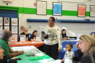 Perusing information about the UFT’s Dial-A-Teacher program for homework help is Denise Joseph, the parent-teacher association vice president at PS 78 on Staten Island.