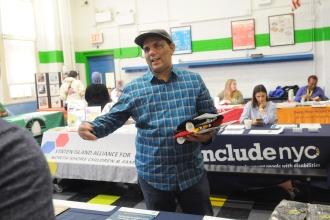 Koby Kohulan, the parent of a third-grader and a fifth-grader, says hello to a colleague at the resource fair.
