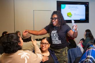 School social worker Samantha Belfon of PS 682 in Brooklyn wears her pride on her chest as she greets colleagues during an ice breaker opportunity.