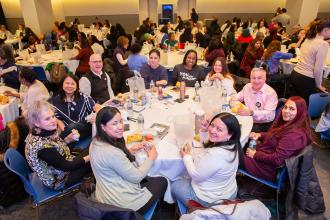 Social workers make connections with their colleagues over lunch as they fill Shanker Hall at union headquarters.