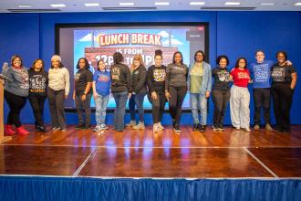 School social workers take to the stage during lunch to show off their T-shirts and their pride in what they do.