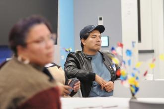 A man listens in while sitting at a table