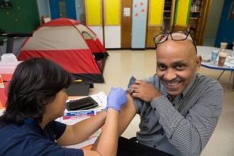 Man receiving a shot by nurse