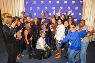 LeRoy Barr is surrounded by well-wishers after receiving the Charles Cogen Award during Teacher Union Day on November 2, 2025. 