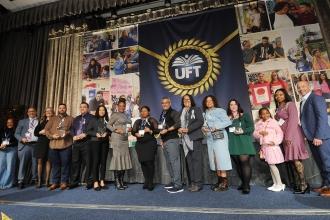 Middle school chapter leaders gather on stage after receiving Ely Trachtenberg Awards from UFT Vice President for Middle Schools Richard Mantell (far right).
