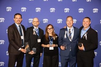 Chapter Leaders (from right) Brian Boggan of Celia Cruz HS, Drew Pecunia of Kingsbridge International HS, Marilyn Martin  of Discovery HS and Seth Gilman of the HS for Teaching and the Professionals are congratulated by Bronx High School Representative Daniel Rodriguez (left) after the members receive an Albert Lee Smallheiser Awards for working together to rebuild a library at the Walton Educational Campus where their schools are co-located.  