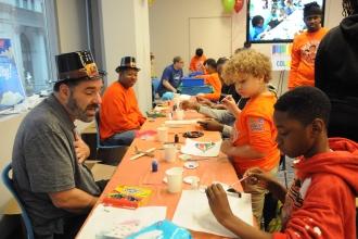 Michael Martin, a 3-K teacher at PS 157 in the Bronx, volunteers to lead a model-airplane-painting activity.