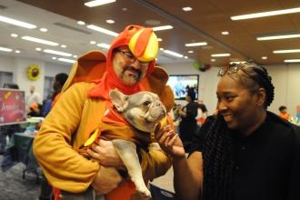 Volunteers dressed up as turkeys for the occasion, both man and pup, greet Crystal Johnson, a special education teacher in District 29 in Queens, who chaperoned a group of students to the luncheon.