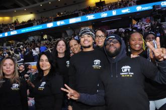 A group of UFT members take a photo during the Tier 6 Rally at MVP Arena in Albany on March 8, 2026