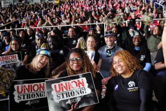 A group of UFT members take a photo during the Tier 6 Rally at MVP Arena in Albany on March 8, 2026