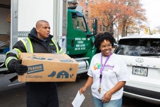 Nubany Perez, community school director of ISLA, located on the Walton HS campus in Kingsbridge, meets the truck delivering chicken to distribute.