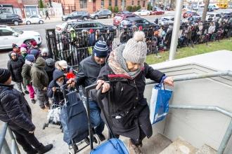 Grateful families begin entering ISLA starting early afternoon to get their bags of food.  