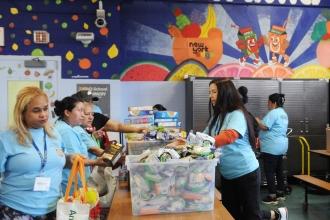  Parent volunteers at PS 14 arrive about 9 a.m. to pack up dry and canned goods for distribution.