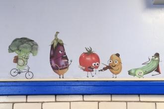 Pictures of fruit and vegetables line the walls of PS 14’s food pantry.
