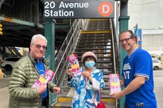 Three UFT members showing campaign literature