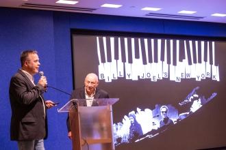 Author Clive Young delivers a keynote address about singer Billy Joel’s New York at the 30th annual UFTWF Day at the University on June 13, 2025. 