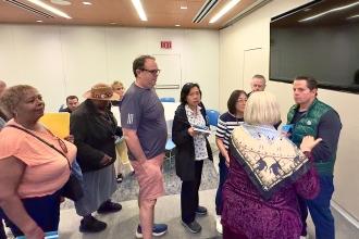 Retirees line up to have Scaramucci sign copies of one of his recent books, which he gave to all attendees following his speech at the 2025 UFTWF Day at the University.