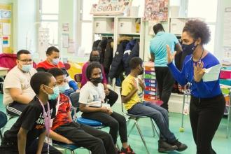 Teacher Michelle Patrovani talks to the student authors about the program, which fosters literacy and creativity.