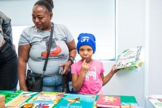 A woman and her daughter pick out books given away at the UFT's Bronx KidZone and Community Resource Fair on Oct. 4.
